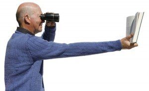Nearsighted man using binoculars to read